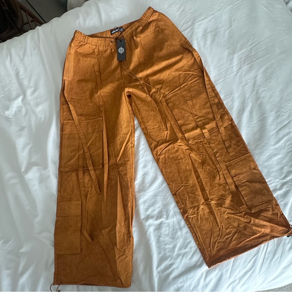 Lux To Kill Oversized Cargo Tech Pants with Oversized Cargo Pockets in Orange.